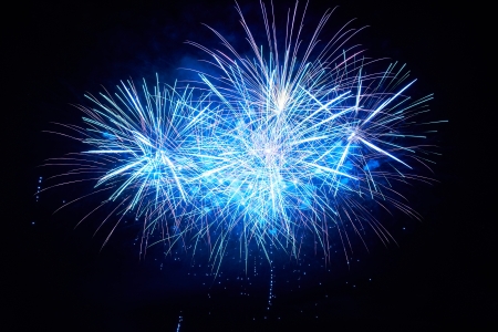 Blue colorful fireworks on the black sky backgroundの写真素材
