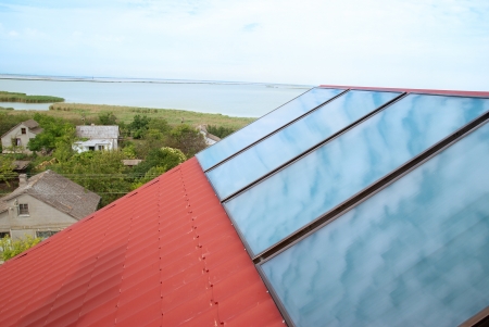 Solar (helio) heating system on the red house roofの写真素材