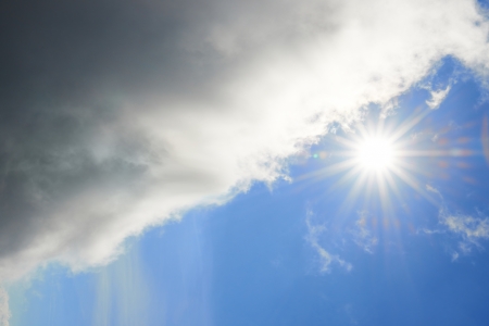 Beautiful blue sky with sun and cloudsの写真素材