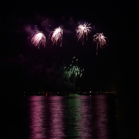 Red colorful holiday fireworks on the black sky background.の写真素材