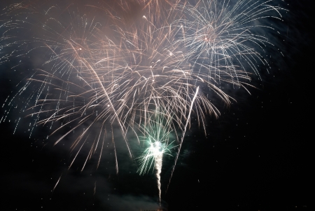 Colorful holiday fireworks on the black sky background.の写真素材