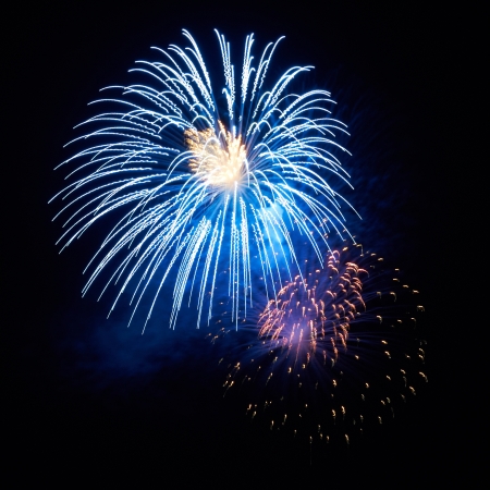 Blue colorful holiday fireworks on the black sky background.の写真素材
