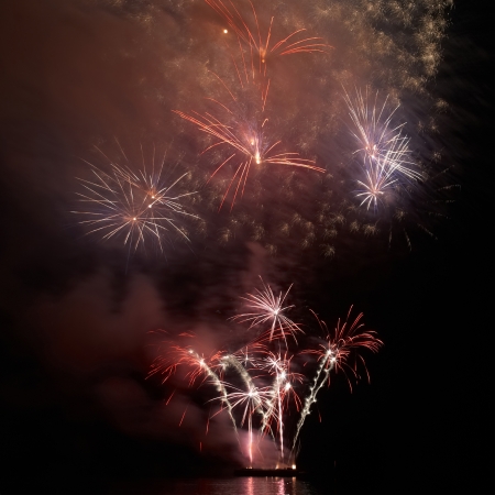 Colorful holiday fireworks on the black sky background.の写真素材