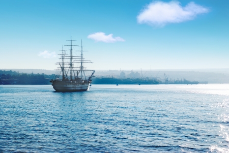 Beautiful sailing vessel in the sea comes into bayの写真素材