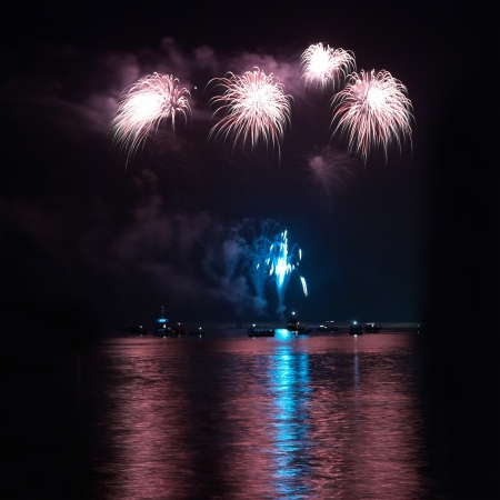 Colorful holiday fireworks on the black sky background.の写真素材