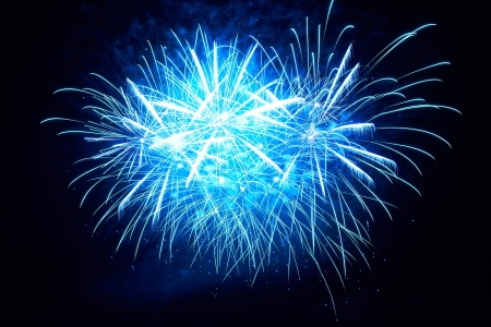 Blue colorful fireworks on the black sky backgroundの写真素材