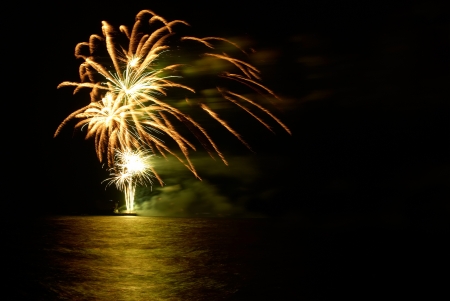 Yellow colorful holiday fireworks on the black sky background.の写真素材