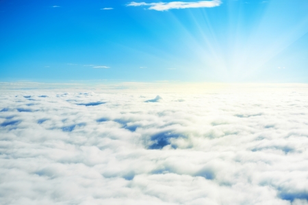 Blue sky and clouds. Plane view above the earth, can be used for backgroundの写真素材