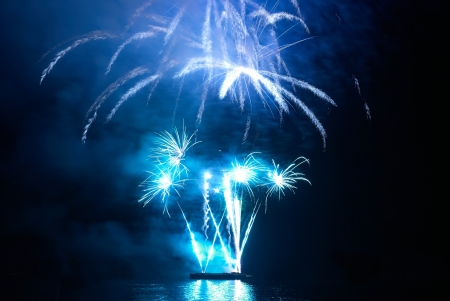 Blue colorful holiday fireworks on the black sky background.の写真素材