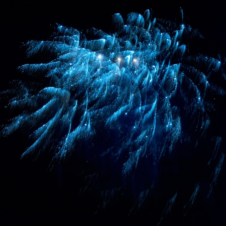 Blue and red colorful holiday fireworks on the black sky background.の写真素材