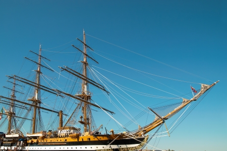 Beautiful sailing vessel with big masts on the mooringの写真素材