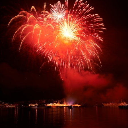 Red colorful fireworks on the black sky backgroundの写真素材