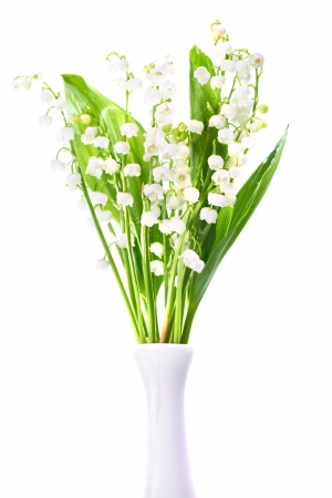 White flowers lilies of the valley in the vase isolated on white backgroundの写真素材