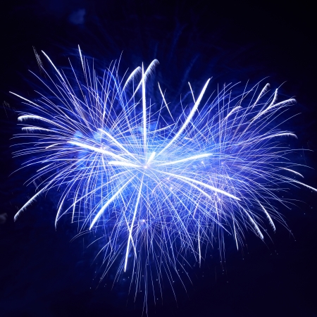 Heart shape of blue colorful fireworks on the black sky backgroundの写真素材