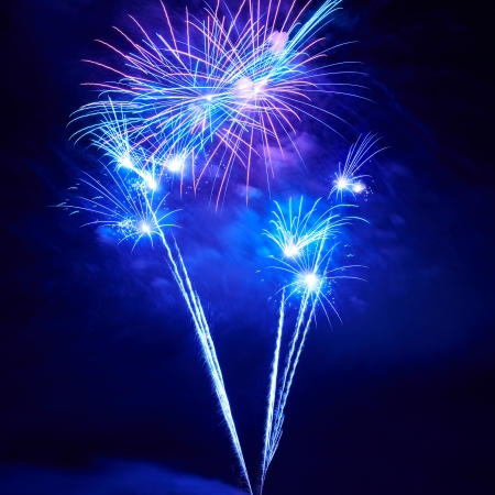 Blue colorful fireworks on the black sky backgroundの写真素材