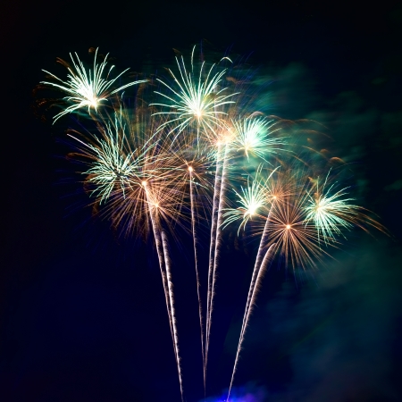 Red colorful fireworks on the black sky backgroundの写真素材