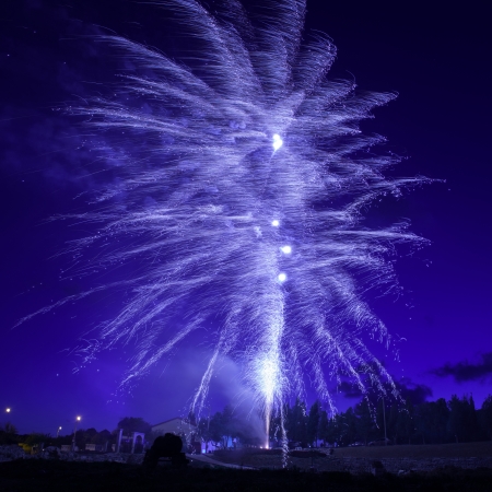 Blue colorful fireworks on night sky 