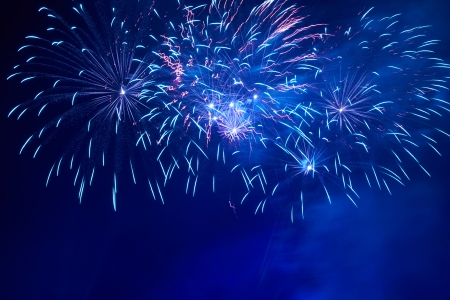 Blue colorful fireworks on the black sky の写真素材