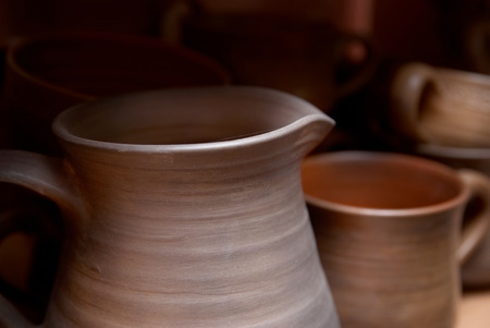 Many handmade old clay pots on the shelf の写真素材