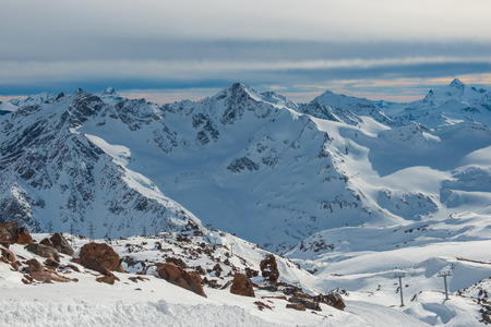 Snowy blue mountains in clouds  Winter ski resort