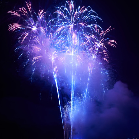 Blue colorful fireworks on the black sky backgroundの写真素材