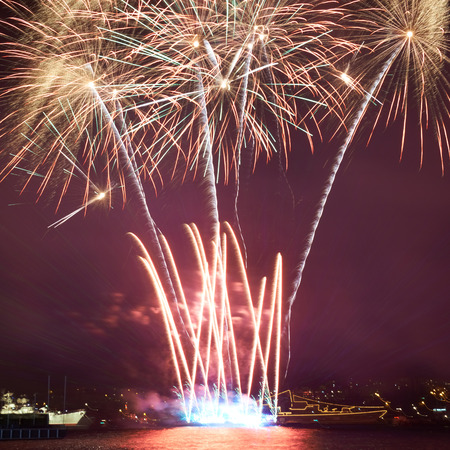 Red colorful fireworks on the black sky backgroundの写真素材