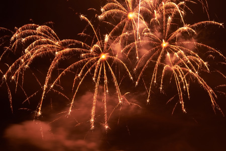 Red colorful fireworks on the black sky backgroundの写真素材