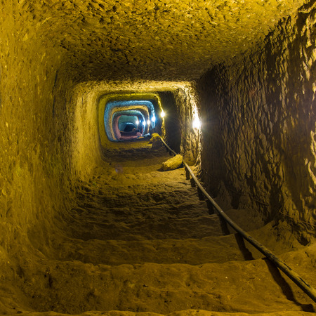 Mysterious dungeon- tunnel with walls made of stoneの写真素材