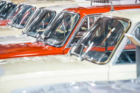 Red and white cars in a row on parking lot 
