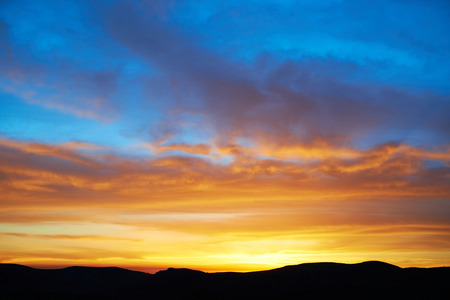 Land with and dramatic colorful sky at sunsetの写真素材