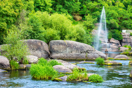 Fountain in the lake between tropical forest. Environment sunny landscapeの写真素材