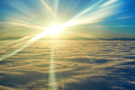 Amazing view from plane on the sky, sunset sun and cloudsの写真素材