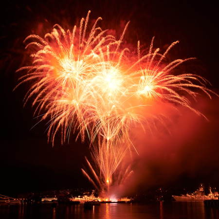 Red colorful fireworks on the black sky backgroundの写真素材