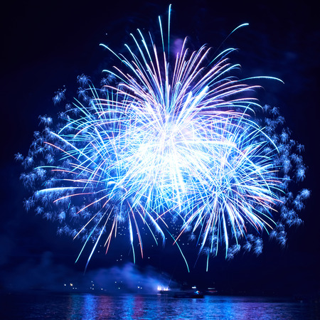 Blue colorful fireworks on the black sky backgroundの写真素材