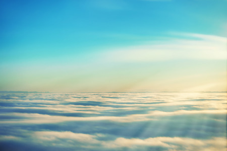 Amazing view from plane on the sky, sunset sun and cloudsの写真素材