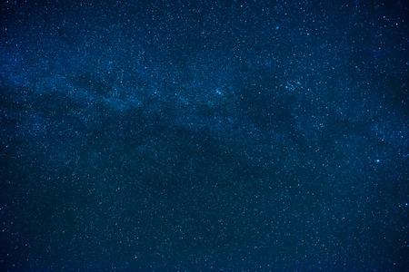 Blue dark night sky with many stars. Milky way on the space backgroundの写真素材