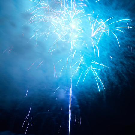 Blue colorful holiday fireworks on the black sky background.の写真素材