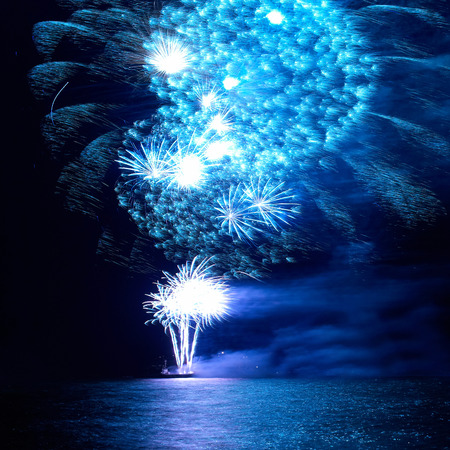 Blue colorful holiday fireworks on the black sky background.の写真素材