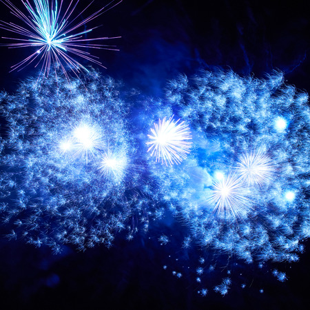 Blue colorful fireworks on the black sky backgroundの写真素材