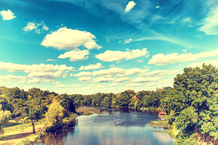 Landscape with river, forest, blue sky and clouds. Ukraine.