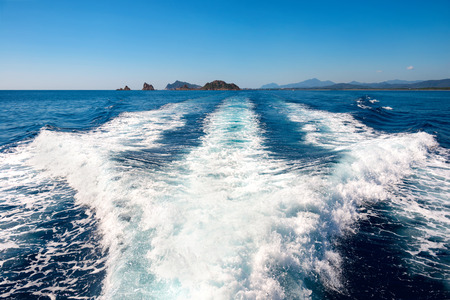 Waves on blue sea behind the speed boat water in sunny dayの写真素材