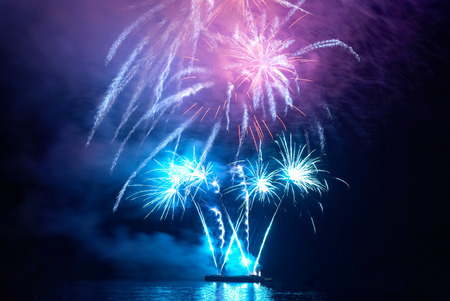 Blue colorful holiday fireworks on the black sky background.の写真素材