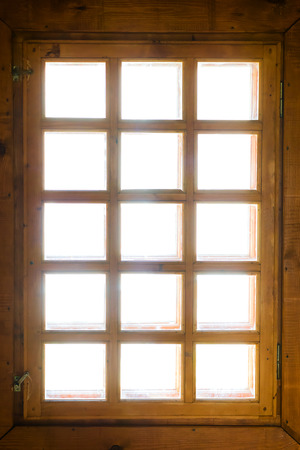 Wooden window with bars isolated on whiteの写真素材