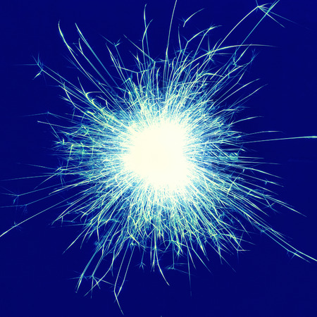 Blue holiday sparkle- fireworks on the black background. Instagram filter.の写真素材