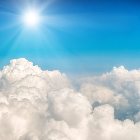 Blue clouds and sky. Shining sun on natural backgroundの写真素材
