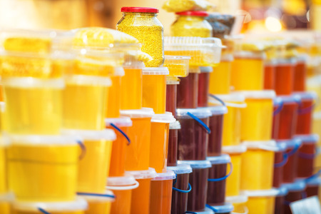 Many jars with honey on farm market