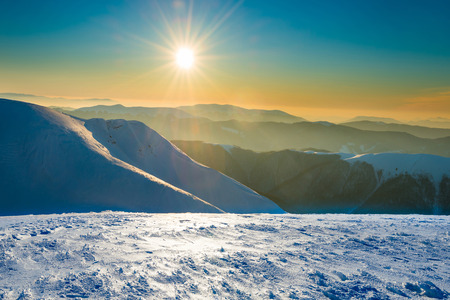 Sunset in winter mountains covered with snow.の写真素材