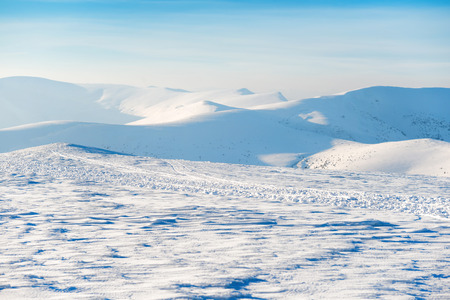 Beautiful winter landscape with snow mountains and blue sky