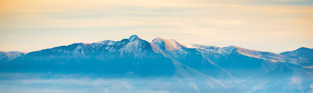 Panorama of high mountain range at sunset timeの写真素材