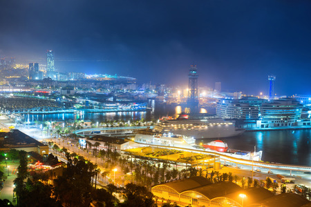 City of Barcelona at night. View on port and cityscape with blue dark skyの写真素材